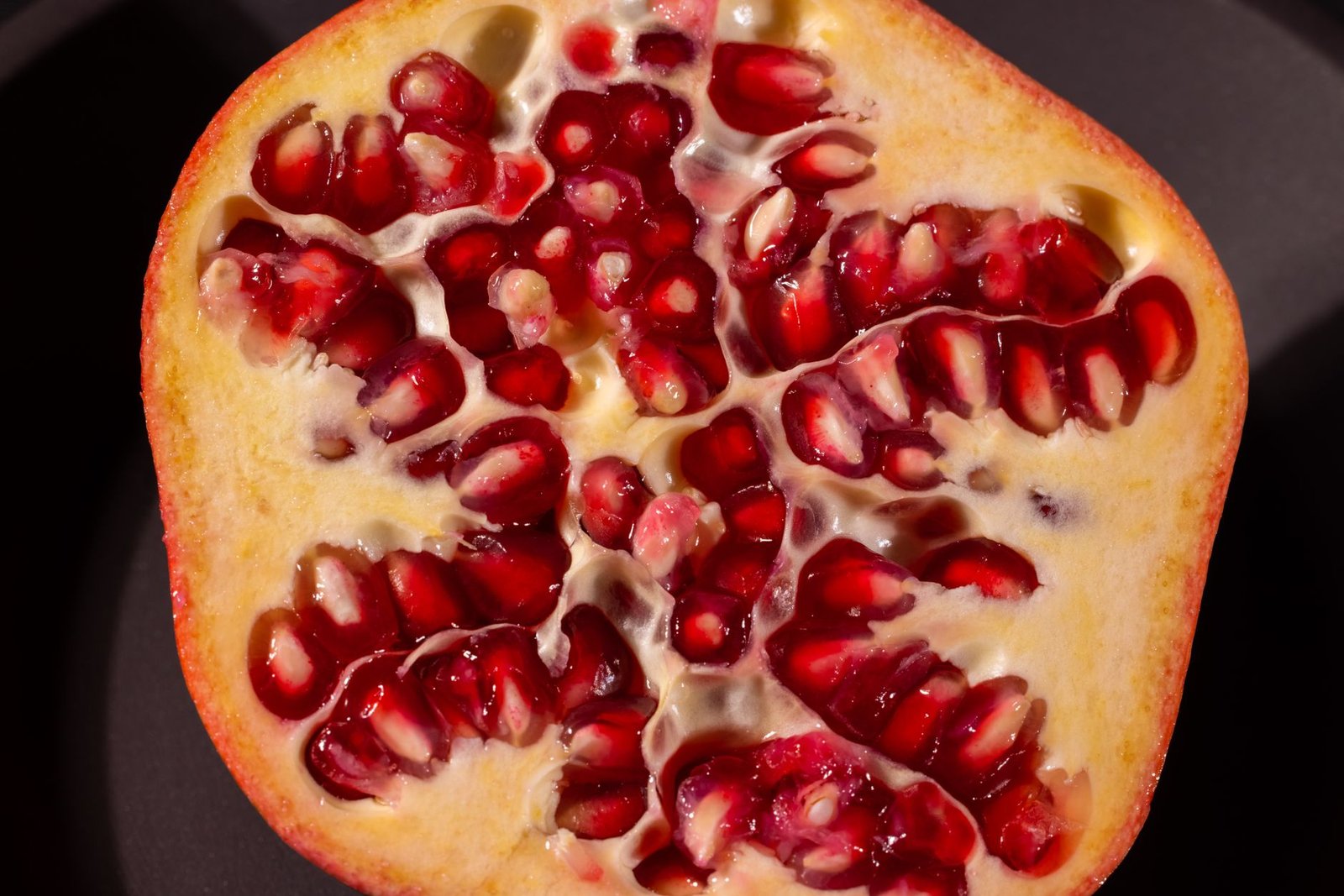 A glass of pomegranate juice with a sprinkle of sugar